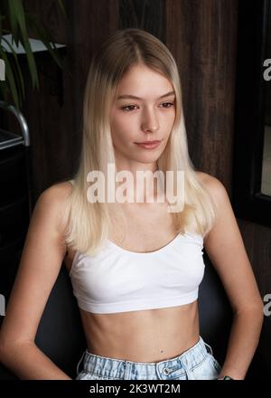 Jeune femme dans un salon de coiffure avant de colorer sa blonde de cheveux Banque D'Images