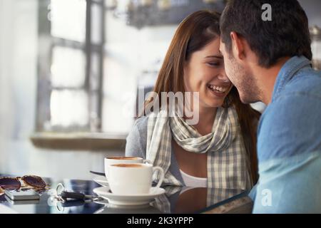 Son sourire est permanent quand shes avec lui. Un jeune couple aimant dans un café ensemble. Banque D'Images