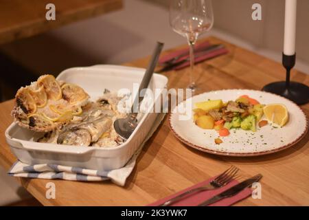 Poisson en croûte de sel avec champignons, brocoli et citron. Banque D'Images