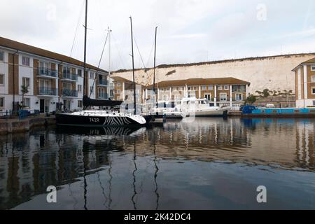 Bateaux à Brighton Marina, East Sussex, ville de Brighton et Hove, Royaume-Uni. Un logement résidentiel composé d'appartements et d'appartements de luxe entoure les baies et l'amarrage des bateaux. (131) Banque D'Images