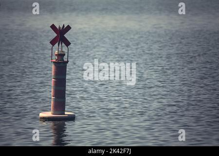Bouée sur un lac au coucher du soleil Banque D'Images