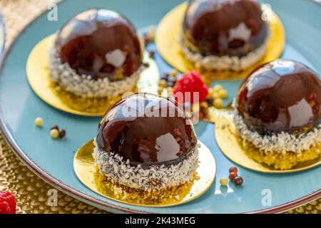 Gâteau à la framboise sur une assiette bleue et décoration chocolat sur une table beige. Dessert aux baies. Soufflé au gâteau léger et aéré. Délicieux petits gâteaux et Banque D'Images