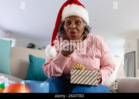 Femmes afro-américaines séniors attentionnés portant un chapeau de père noël Banque D'Images