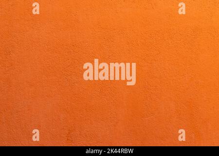 Arrière-plan de texture murale peinte orange. Banque D'Images