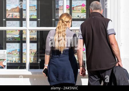 La photo datée de 29 septembre montre les gens regardant dans les fenêtres d'agents immobiliers à Ely, Cambridgeshire, que l'inquiétude au sujet de l'hypothèque continue. Une « bombe à retardement » de prêts hypothécaires attend si les taux d'intérêt britanniques augmentent à la suite des prévisions du marché, a averti Martin Lewis. S’exprimant sur le Good Morning Britain d’ITV, le champion du consommateur a suggéré que ceux qui avaient des prêts hypothécaires à taux variable ou des offres à taux fixe arrivant à échéance dans les trois à cinq prochains mois pourraient consulter un site Web de comparaison pour voir ce qui est actuellement disponible. Banque D'Images