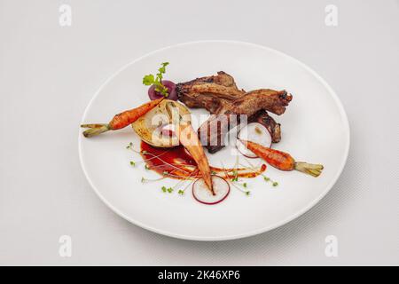 Côtes de porc grillées aux légumes, sauce barbecue, isolé sur fond blanc, vue de dessus Banque D'Images