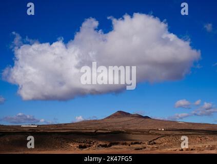 Paysage de volcan solitaire avec ciel bleu et grand nuage blanc Banque D'Images