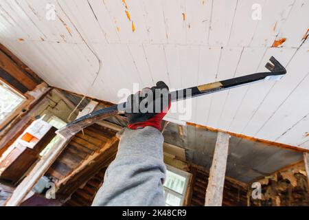 Arrache-clou noir à main mâle, démolition de maison en cours Banque D'Images