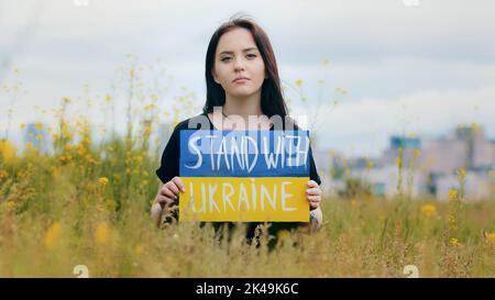 Portrait de la fille bouleversée femme patriote tenant carton inscription slogan politique stand avec l'Ukraine demandant le soutien de démonstration de l'illustration de bannière Banque D'Images