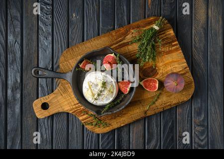 Vue de dessus du fromage camembert cuit au four et des figues sur la poêle à frire Banque D'Images