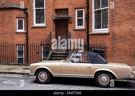 Voiture Mercedes cabriolet d'époque garée à l'extérieur des maisons en briques rouges à Cadogan Square, Chelsea, le 7th septembre 2022 à Londres, Royaume-Uni. Cette région de l'ouest de Londres, dans la ville de Westminster et le Royal Borough de Kensington et Chelsea, est réputé pour ses propriétés résidentielles très chères et est l'un des quartiers les plus riches du monde. Banque D'Images