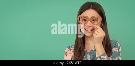 Heureux Tween fille sourire portant des lunettes de soutien en forme de coeur pour la fête de jour de Valentines. Adolescent drôle sur la fête, affiche en-tête de bannière avec espace de copie Banque D'Images