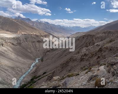 Vallée de la rivière Pamir dans le désert entre l'Afghanistan et le Tadjikistan dans le corridor de Wakhan avec la chaîne de montagnes Hindu Kush en arrière-plan, Gorno-Badakshan Banque D'Images