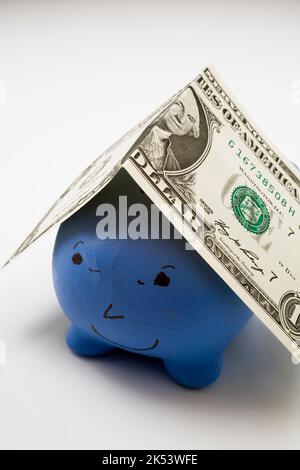 Billet d'un dollar sur la tirelire en céramique bleue. Banque D'Images