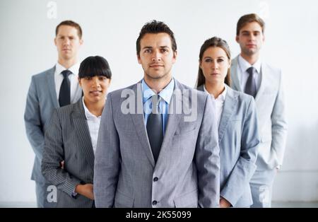 Vous êtes prêt à tout. Portrait d'une équipe d'affaires confiante debout au bureau. Banque D'Images
