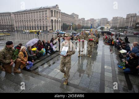 Les soldats ukrainiens portent le portrait et les prix militaires de Roman Kosenko, surnommé Yashka, qui est décédé lors des combats avec les troupes russes à Izium, dans l'est de l'Ukraine, lors de la cérémonie funéraire sur la place de l'indépendance à Kiev. Banque D'Images
