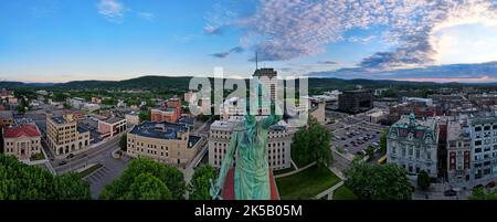 Une photo panoramique aérienne du paysage urbain du centre-ville de Binghamton, avec une statue verte au milieu Banque D'Images