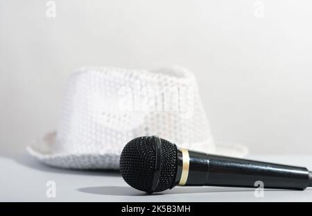 Un chapeau et un microphone de fête à paillettes argentées. Chapeau à la paaillette et microphone de l'animateur. Montrez les accessoires de l'hôte Banque D'Images