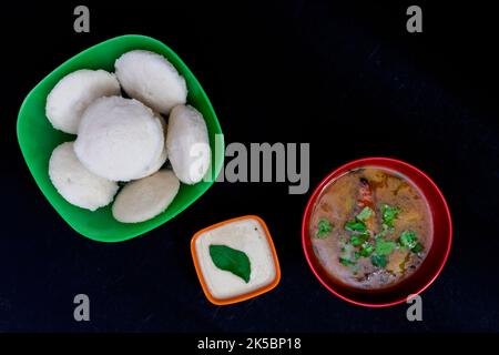 Sambar avec chutney à la noix de coco, isolé sur fond noir, petit déjeuner indien du Sud, Sin in Green Square Bowl, Sambar dans Red Round Bowl, Coconut Banque D'Images