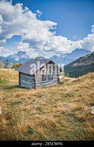 Italie, Vénétie, province de Belluno, Rocca Pietore, Laste alm. Chalet rustique en bois sur un plateau vert de haute montagne dans les Dolomites Banque D'Images