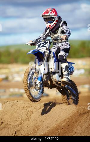 S'attaquer à chaque obstacle. Un motocross faisant un petit saut. Banque D'Images