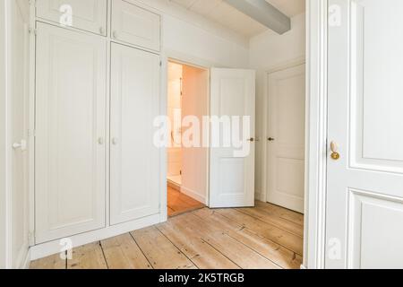 fauteuil placé sur parquet près de la fenêtre dans la spacieuse pièce lumineuse de la maison Banque D'Images