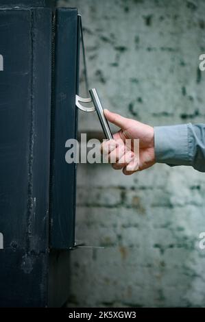 Poignée de porte en métal pour la cheminée, pierre en métal pour le chauffage, vue sur la cheminée depuis le côté. Banque D'Images