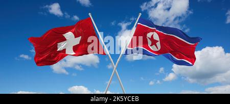 Deux drapeaux croisés la Corée du Nord et la Suisse agitant sous le vent à ciel nuageux. Concept de relation, de dialogue, de voyage entre deux pays. 3d malade Banque D'Images