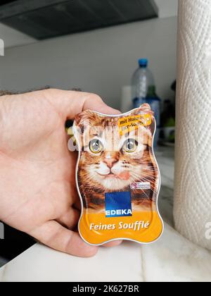 Paris, France - 13 septembre 2022 : sac à main mâle POV avec Edeka Feinnes Souffle pour déguster de la nourriture humide de chat de poulet Jelly avec de la viande de chiken et aloe vera - cuisine moderne fond de préparation pour nourrir l'animal de chat Banque D'Images