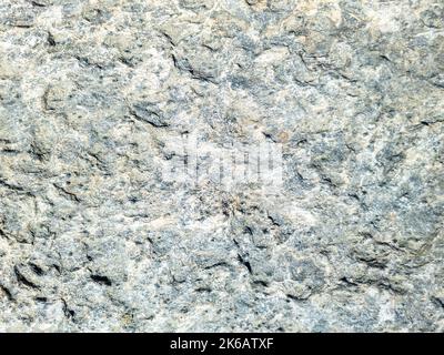 Texture d'arrière-plan de mur en pierre grise beige. Formation rocheuse avec trous, matériau rugueux. Surface dure naturelle abstraite. Île grecque Cyclades Grèce. Banque D'Images