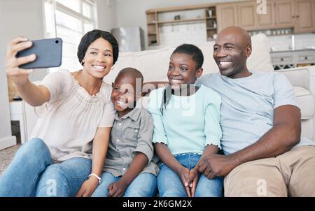 La vie est belle. Il s'agit de donner. Il s'agit de la famille. une famille qui prend un selfie à la maison. Banque D'Images