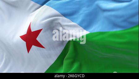 Vue rapprochée du drapeau national de Djibouti agitant dans le vent. La République de Djibouti est un pays de la Corne de l'Afrique. Fond texturé en tissu Banque D'Images