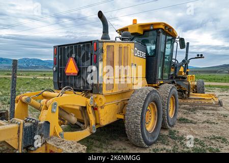 Le compartiment moteur arrière d'une niveleuse John Deere 772GP garée dans un champ de ferme près d'Almo, Idaho, Etats-Unis Banque D'Images