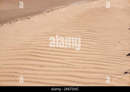 Ondulations dans le sable fait par le vent. Texture des dunes déplacées par le vent. Paysage tropical. Banque D'Images
