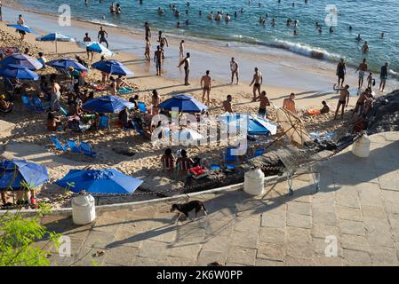 Salvador, Bahia, Brésil - 09 avril 2022: Les Brésiliens et les touristes se baignent sur la plage de Porto da Barra à Salvador pendant un après-midi ensoleillé. Banque D'Images