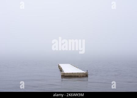 Belle image de paysage minimaliste d'une jetée flottante unique sur le Loch Lomond pendant la neige d'hiver Banque D'Images