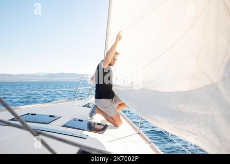 Homme qui navigue sur son bateau Banque D'Images