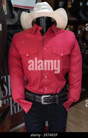 Chemise rouge Charro pour hommes, pantalon noir et chapeau blanc sur le mannequin du magasin. Vêtements de cow-boy mexicains traditionnels Banque D'Images