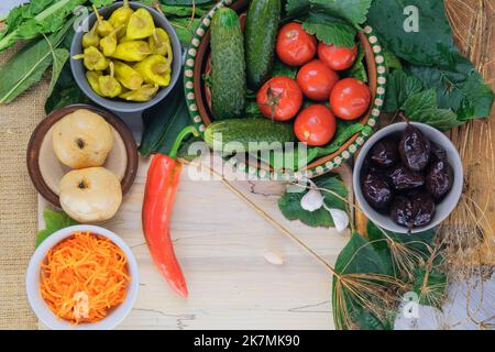 Divers aliments de légumes fermentés : concombres, tomates, pommes, prunes, poivrons et carottes. Nourriture saine dans les bols. Banque D'Images