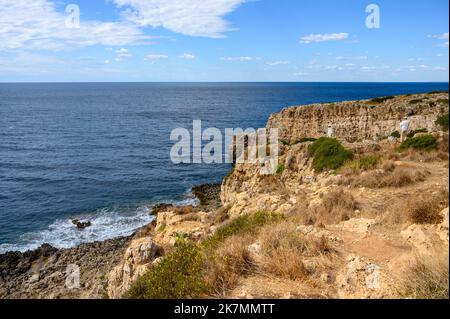 Paysage côtier rocheux avec un couple posant et prenant une photo près du Parc naturel régional de Porto Selvaggio, Apulia (Puglia), Italie. Banque D'Images