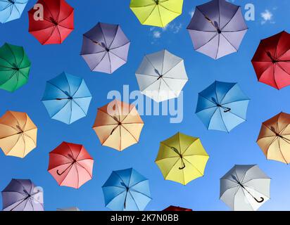 parapluies comme décoration de rue. parasols colorés contre le ciel bleu Banque D'Images