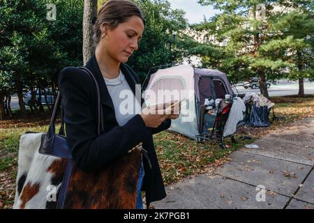 Washington, États-Unis d'Amérique. 14th octobre 2022. Le journaliste Georgia Worrell parle avec un résident d'un campement pour sans-abri dans la partie inférieure du Foggy de Washington, DC, vendredi, 14 octobre 2022 à Washington, DC. Le campement Foggy Bottom est situé juste derrière les États-Unis Département d'État et contient 15 tentes abritant un nombre indéterminé de personnes sans abri. Credit: Jemal Countess/CNP/Sipa USA (RESTRICTION: PAS de journaux ou journaux New York ou New Jersey dans un rayon de 75 miles de New York) Credit: SIPA USA/Alay Live News Banque D'Images