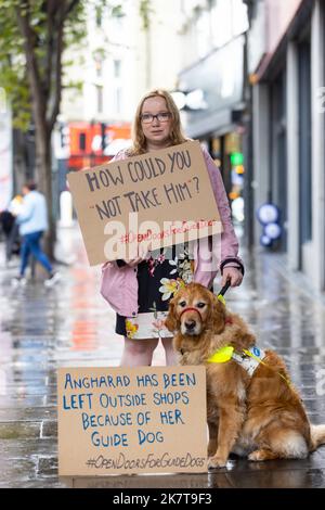 USAGE ÉDITORIAL SEULEMENT propriétaire de chien guide Angharad de Port Talbot avec son chien d'assistance Tudor afficher un écriteau pour sensibiliser les chiens à des refus d'accès illégaux et partager l'impact que cela a sur la vie de leurs propriétaires malvoyants, Londres. Date de publication : mercredi 19 octobre 2022. Banque D'Images