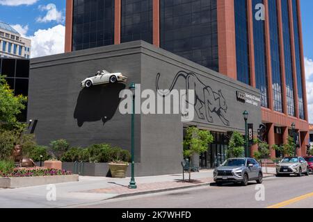 Colorado Springs, CO - 6 juillet 2022 : sculpture de la moitié d'une Porsche accrochée sur le mur sud du centre-ville UCCS, Université du Colorado, Colorado SPR Banque D'Images