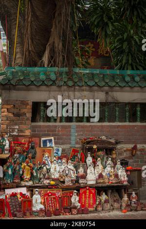 Statuettes de dieux chinois exposées contre le mur extérieur du Temple Tin Hau, Yau Ma Tei, Kowloon, Hong Kong Banque D'Images