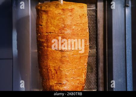 faites cuire le kebab sur une broche avec des tranches de viande grillées du gril dans un restaurant de restauration rapide du moyen-orient. Banque D'Images