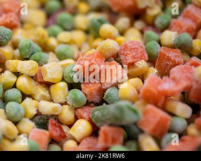 Légumes dépolis colorés carottes, maïs et pois en tas Banque D'Images