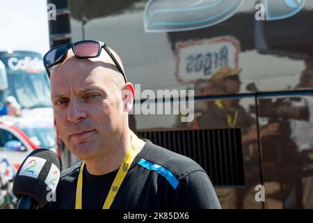 Sir David Brailsford, le principal de Team Sky Procycling, s'entretient avec les médias devant le bus de l'équipe le jour de l'ouverture du Tour de France à Porto Vecchio. Banque D'Images