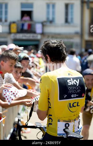 Spectateurs au début de la course avec le maillot jaune de Geraint Thomas signant des autographes au premier plan pendant la phase 18 du Tour de France 2018 Banque D'Images