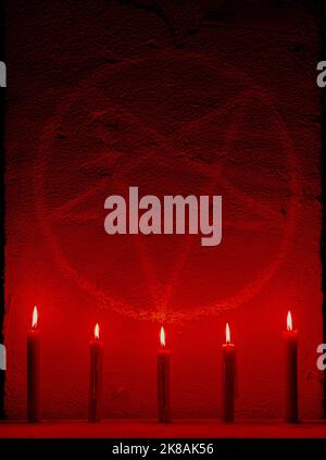 Symbole de pentagramme blanc sur un mur en béton. Autel satanique éclairé de bougies. Arrière-plan sombre. Occultisme effrayant et mystique Banque D'Images